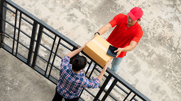 Delivery man giving a parcel to a customer