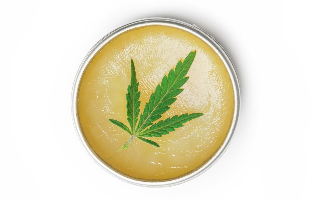 Cannabis cream with cannabis leaf top of it