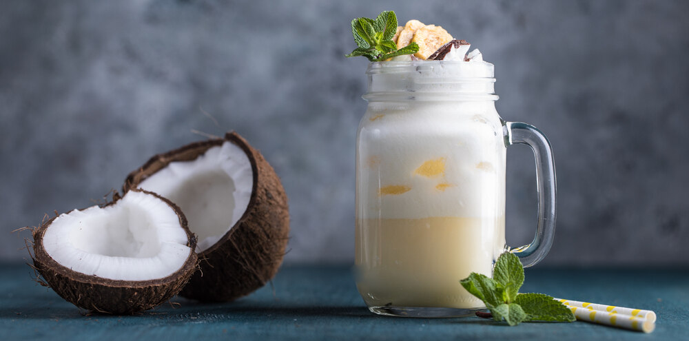 Pina Colada Smoothie with coconut next to it