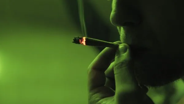 man smoking joint that contains moldy weed